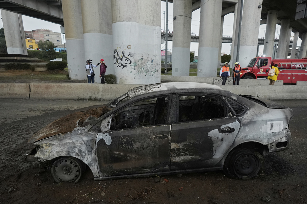 A burned car sits below an underpass following a gas tanker explosion in Mexico City, Wednesday, Sept. 10, 2025. (AP Photo/Fernando Llano)