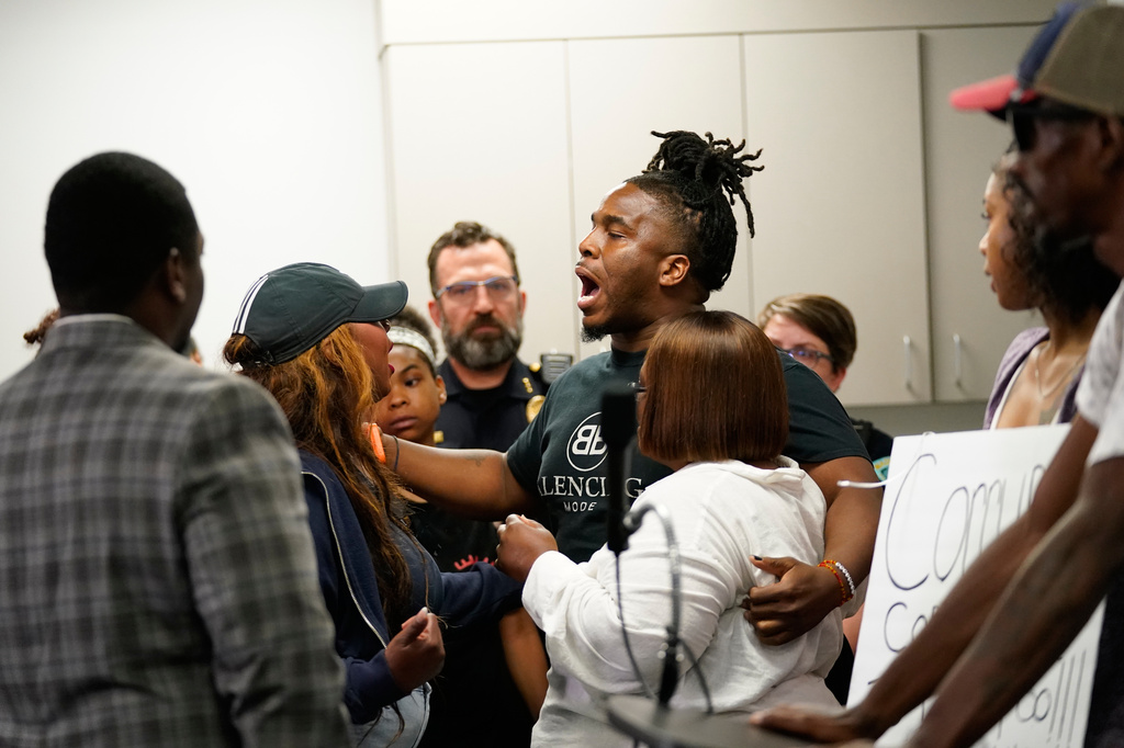Residents react during a press conference regarding the incident where a man was shot and killed on Wednesday by Madison police, Thursday, July 23, 2026, at the police station in Madison, Wis. (AP Photo/Kayla Wolf)