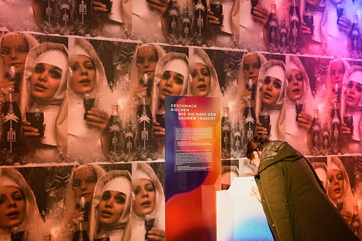 A woman smells samples of Afri-Cola, a popular German soft drink of the 60s and 70s during the exhibition "The Secret Power of Scents", showing the history of scent from antiquity to the present as a sensory experience at the Kunstpalast art museum in Duesseldorf, Germany, Tuesday, Oct. 28, 2025. (AP Photo/Martin Meissner) A woman smells samples of Afri-Cola, a popular German soft drink of the 60s and 70s during the exhibition "The Secret Power of Scents", showing the history of scent from antiquity to the present as a sensory experience at the Kunstpalast art museum in Duesseldorf, Germany, Tuesday, Oct. 28, 2025. (AP Photo/Martin Meissner)
