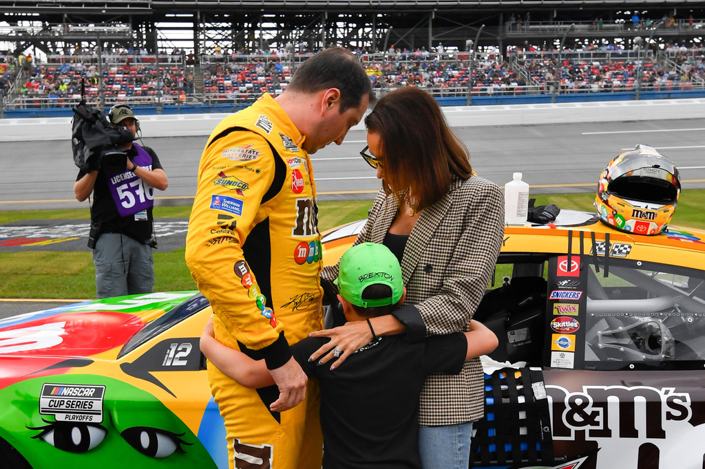 FILE - Kyle Busch, left, son Brexton, center, and wife Samantha put their arms around each other before a NASCAR Cup series auto race Oct. 3, 2021, in Talladega, Ala. (AP Photo/John Amis, File)