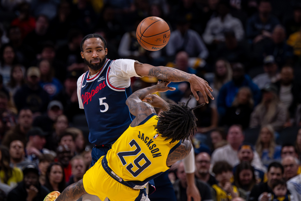 Los Angeles Clippers forward Derrick Jones Jr. (5) blocks a pass-attempt by Indiana Pacers guard Quenton Jackson (29) during the first half of an NBA basketball game in Indianapolis, Friday, March 27, 2026. (AP Photo/Doug McSchooler)