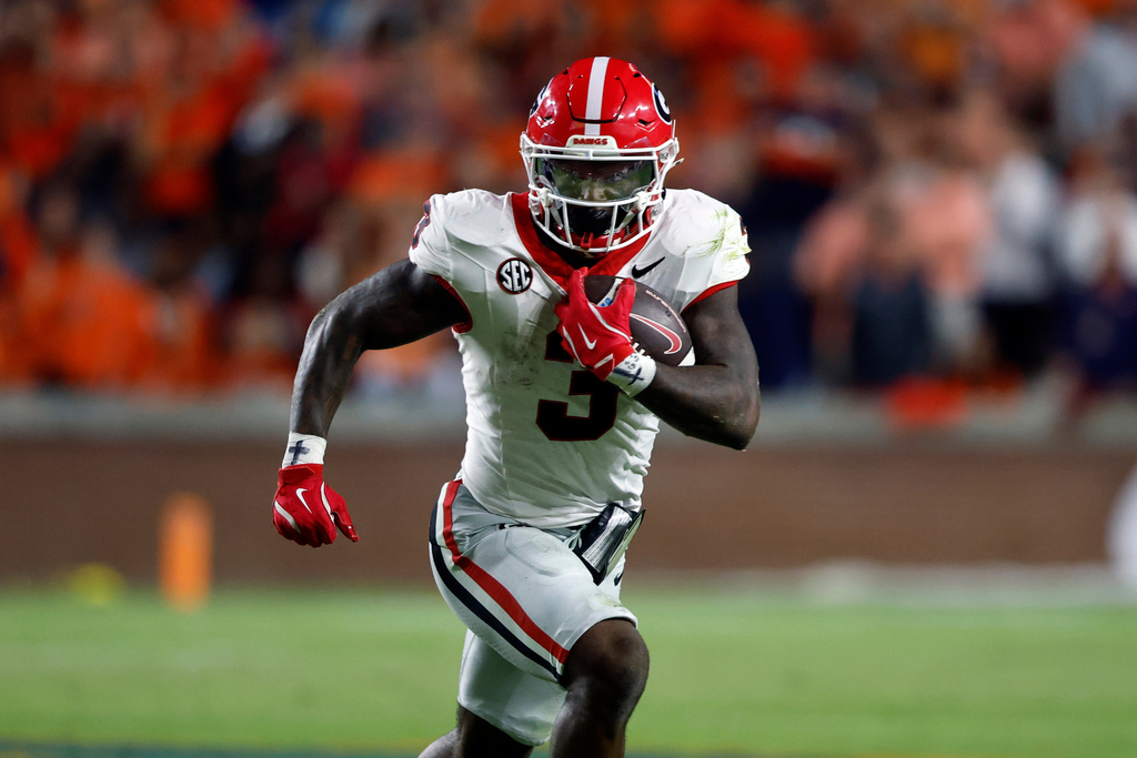 Georgia running back Nate Frazier carries the ball against Auburn during the second half of an NCAA college football game, Saturday, Oct. 11, 2025, in Auburn, Ala. (AP Photo/Butch Dill)