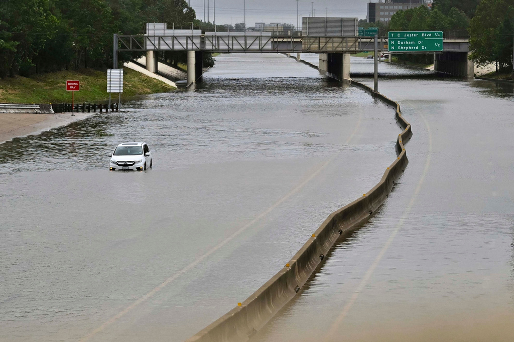 FILE - A vehicle is stranded in high waters on a flooded highway at Interstate 10 and Washington in Houston, July 8, 2024, after Hurricane Beryl came ashore. (AP Photo/Maria Lysaker, File)