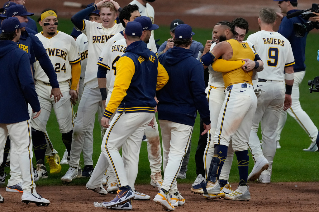 Milwaukee Brewers' Jackson Chourio is congratulated after hitting a walkoff hit during the ninth inning of Game 2 of a National League Divisional baseball playoff series against the San Diego Padres Sunday, Oct. 4, 2026, in Milwaukee. (AP Photo/Chris Carlson)