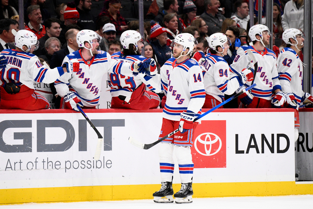 New York Rangers right wing Taylor Raddysh (14) celebrates his goal during the first period of an NHL hockey game against the Washington Capitals, Tuesday, Dec. 23, 2025, in Washington. (AP Photo/Nick Wass)