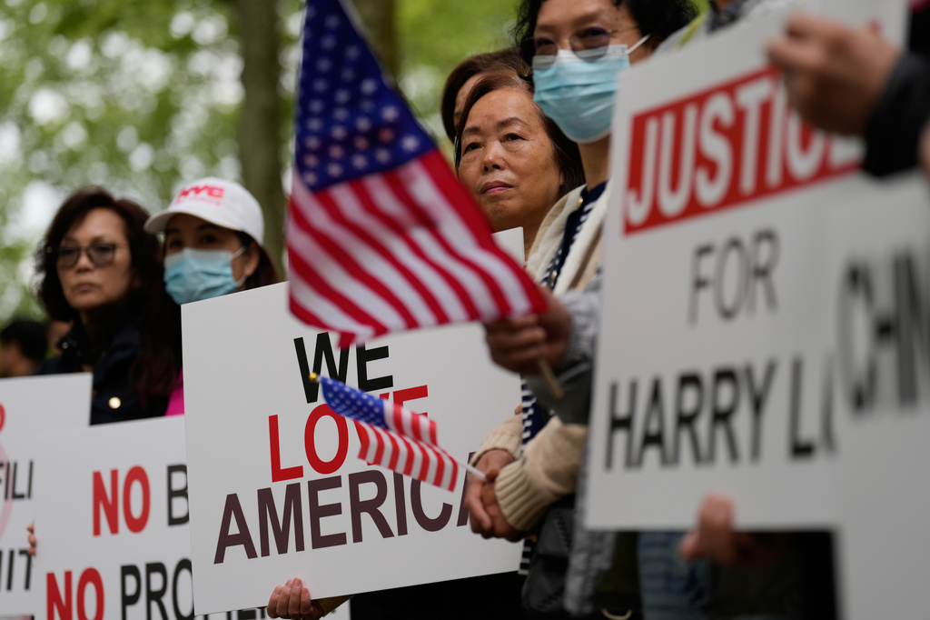 Supporters of Lu Jianwang, also known as Harry Lu, stand outside a federal courthouse before the opening of his trial in New York, Wednesday, May 6, 2026. (AP Photo/Seth Wenig)