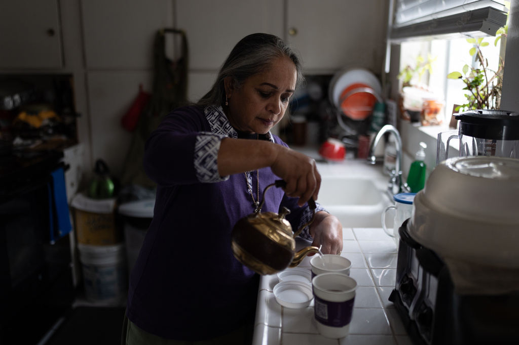 Masuma Khan, an immigrant from Bangladesh who was held at an immigration detention facility in California City the previous year, makes tea in her home in Altadena, Calif., April 21, 2026. (AP Photo/Jae C. Hong)