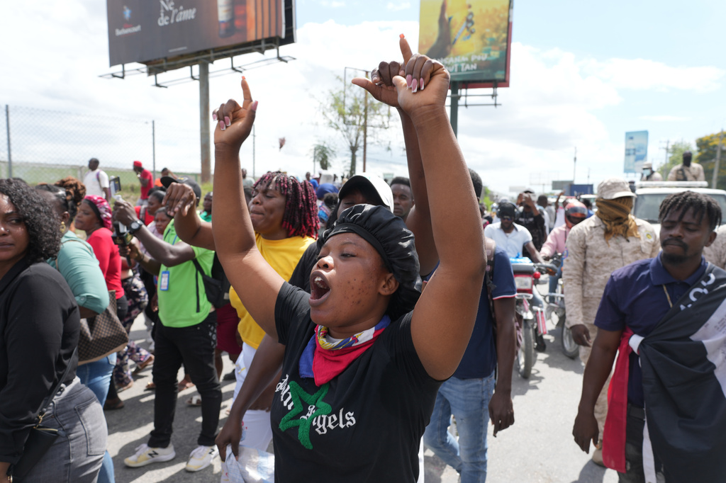 Factory workers march to demand a salary increase in Port-au-Prince, Haiti, Monday, April 13, 2026. (AP Photo/Odelyn Joseph)
