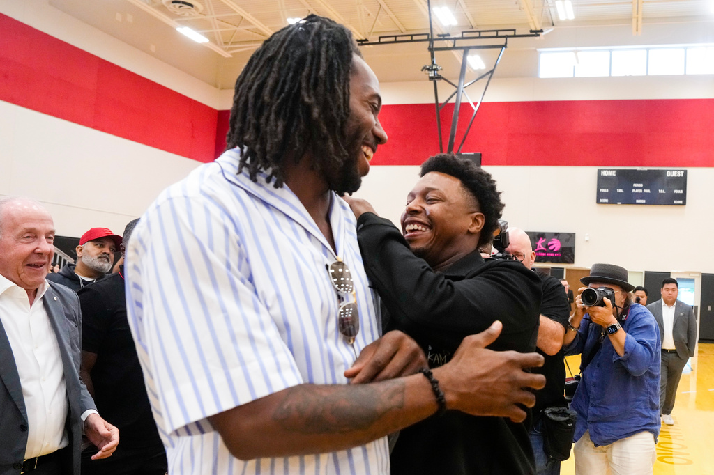 Kyle Lowry, right, speaks with Kawhi Leonard after a press conference in which Lowry signed a one-day contract to retire as a Toronto Raptor, in Toronto, on Tuesday, July 7, 2026. (Chris Young/The Canadian Press via AP)