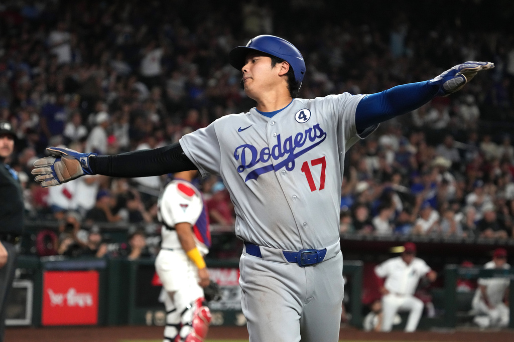 Los Angeles Dodgers' Shohei Ohtani reacts after scoring on a single hit by Mookie Betts against the Arizona Diamondbacks in the seventh inning of a baseball game, Tuesday, June 2, 2026, in Phoenix. (AP Photo/Rick Scuteri)