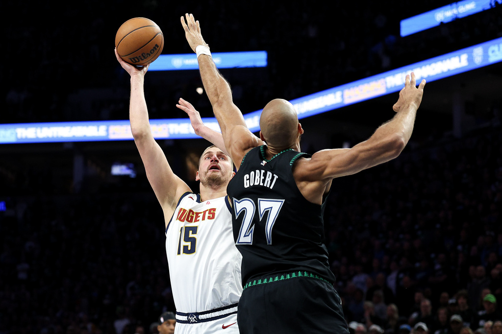Denver Nuggets center Nikola Jokic, left, looks to shoot over Minnesota Timberwolves center Rudy Gobert (27) during the first half of Game 6 of a first-round NBA basketball playoffs series, Thursday, April 30, 2026, in Minneapolis. (AP Photo/Matt Krohn)