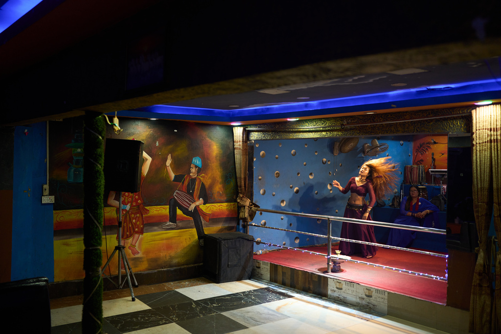 A dancer performs in a club in Hetauda, Nepal, Saturday, May 16, 2026. (AP Photo/Bram Janssen)