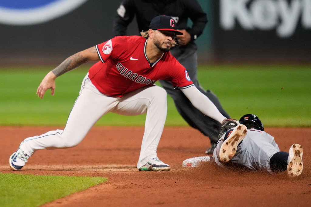 Cleveland Guardians shortstop Gabriel Arias, left, tags out Detroit Tigers' Zach McKinstry, right, at second base on an attempted steal in the sixth inning of a baseball game in Cleveland, Thursday, Sept. 25, 2025. (AP Photo/Sue Ogrocki)