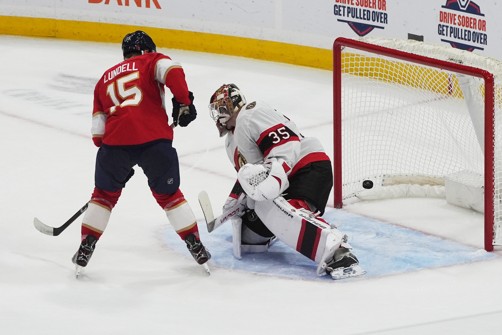 Florida Panthers center Anton Lundell (15) scores a goal against Ottawa Senators goaltender Linus Ullmark (35) during the second period of an NHL hockey game, Saturday, Oct. 11, 2025, in Sunrise, Fla. (AP Photo/Marta Lavandier)