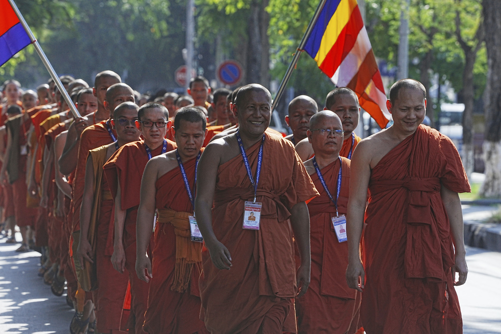 Cambodian Buddhist monks march on a street as they organize a religious ceremony to honor soldiers killed in recent border clashes with Thai forces and to pray for peace in Phnom Penh, Cambodia, Friday, Aug. 8, 2025. (AP Photo/Heng Sinith)