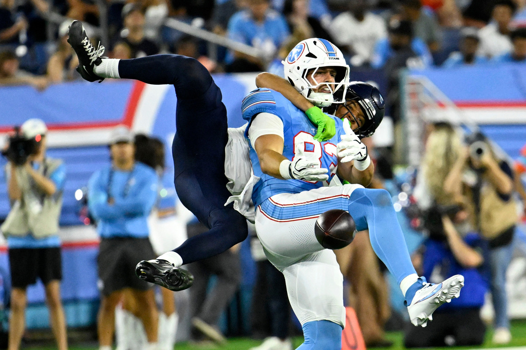 Seattle Seahawks cornerback Jordan Washington, rear, breaks up a pass intended for Tennessee Titans tight end Joel Wilson (83) during the second half of a preseason NFL football game, Sunday, Aug. 23, 2026, in Nashville, Tenn. (AP Photo/John Amis)