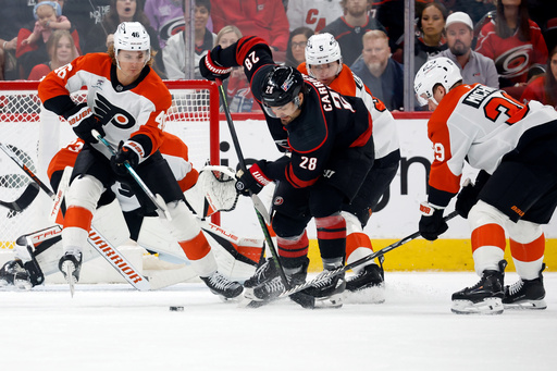 Carolina Hurricanes' William Carrier (28) controls the puck between Philadelphia Flyers defenders during the first period of an NHL hockey game in Raleigh, N.C., Saturday, Oct. 11, 2025. (AP Photo/Karl DeBlaker) Carolina Hurricanes' William Carrier (28) controls the puck between Philadelphia Flyers defenders during the first period of an NHL hockey game in Raleigh, N.C., Saturday, Oct. 11, 2025. (AP Photo/Karl DeBlaker)