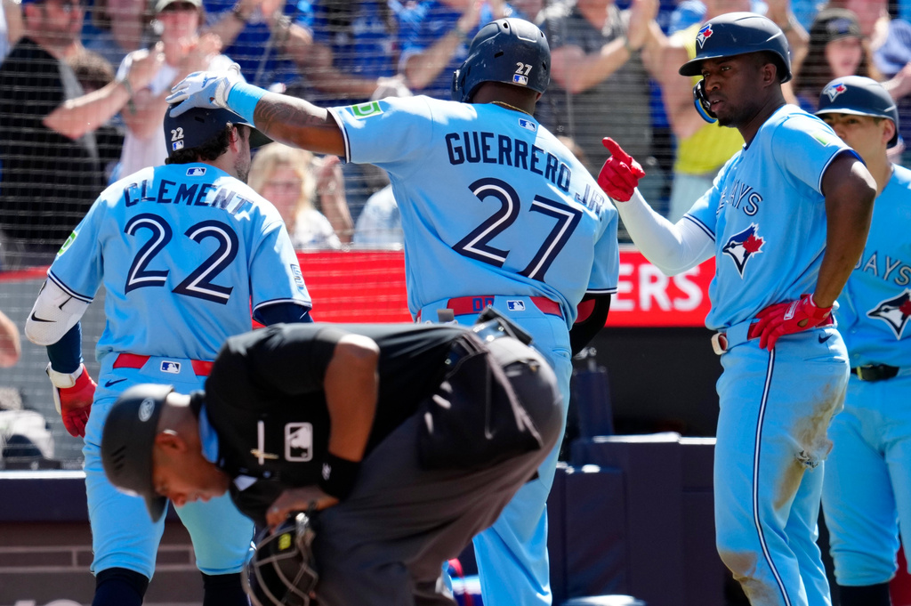 Toronto Blue Jays' Ernie Clement (22) is greeted by teammates after hitting a three-run home run during the third inning of a baseball game against the Baltimore Orioles, Saturday, June 6, 2026, in Toronto. (Frank Gunn/The Canadian Press via AP)
