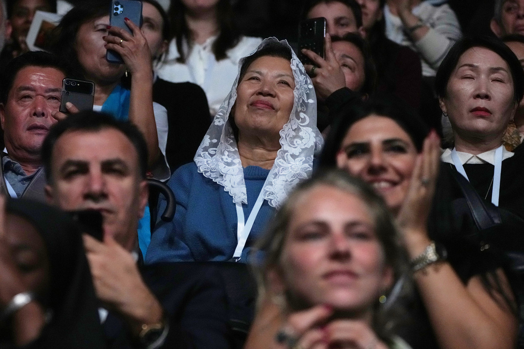 People attend a Mass celebrated by Pope Leo XIV at the Volkswagen Arena, in Istanbul, Turkey, Saturday, Nov. 29, 2025. (AP Photo/Dilara Acikgoz)
