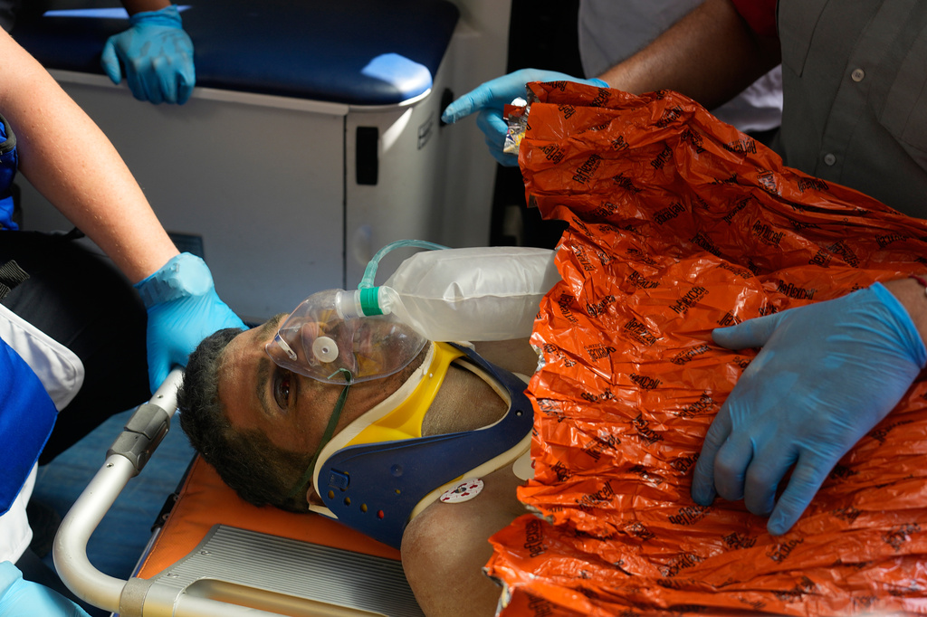 Rescue workers attend to Hernán Alberto Gil Flores after he was pulled from the rubble eight days after he was trapped by twin earthquakes that struck Catia La Mar, Venezuela, Thursday, July 2, 2026. (AP Photo/Fernando Vergara)