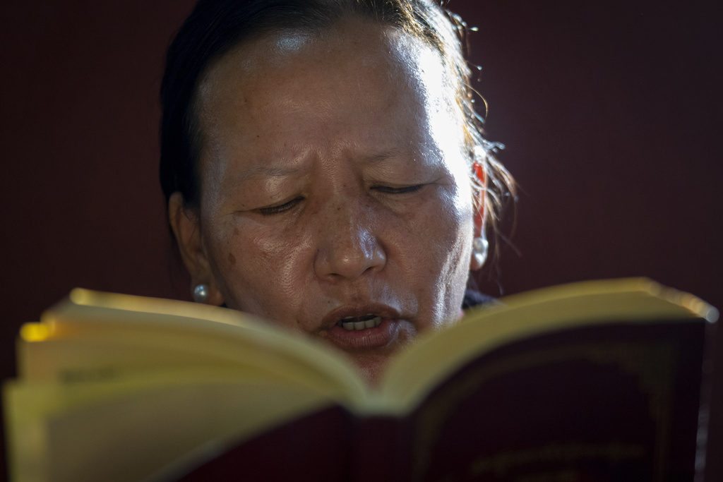 A Tibetan woman offers a prayer in the remembrance of those who lost their lives in the recent earthquake, at a Tibetan camp in Lalitpur, Nepal, on Wednesday, Jan. 8, 2025. (AP Photo/Niranjan Shrestha)