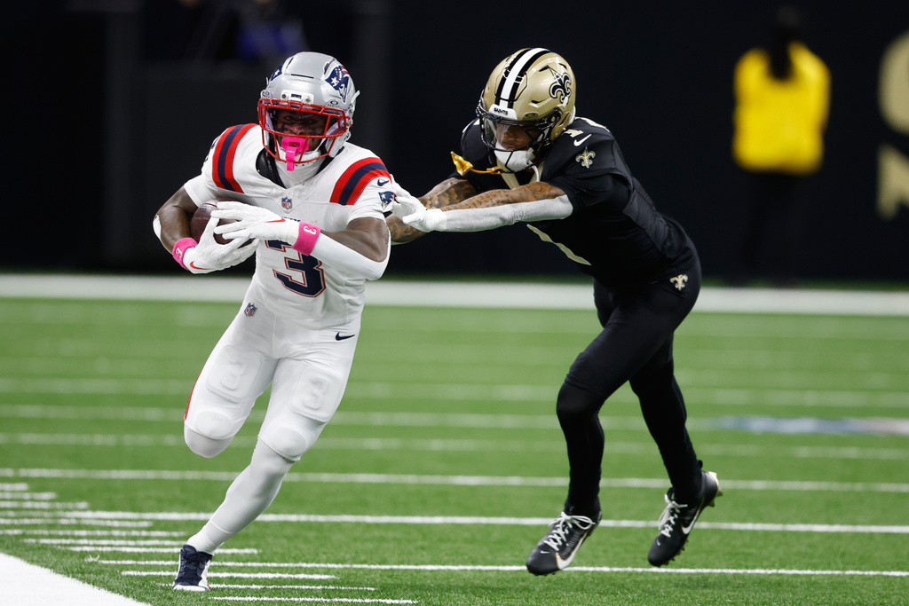 New England Patriots wide receiver Demario Douglas, left, is pushed out of bounds by New Orleans Saints cornerback Alontae Taylor during the first half of an NFL football game, Sunday, Oct. 12, 2025, in New Orleans. (AP Photo/Butch Dill)