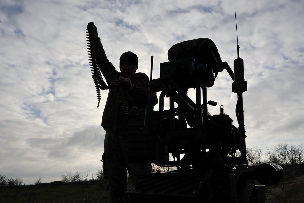 In this photo, provided by Ukraine's 65th Mechanized Brigade press service, a soldier tests land drones in Zaporizhzhia region, Ukraine, Saturday, Dec. 6, 2025, (Andriy Andriyenko/Ukraine's 65th Mechanized Brigade via AP)