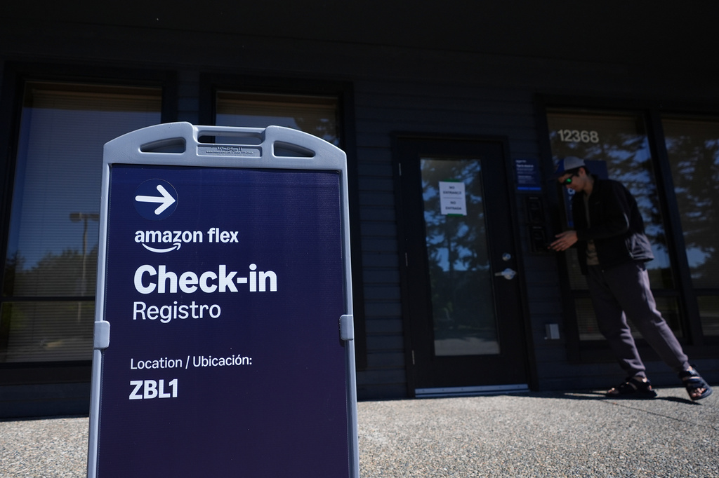 A driver checks in before picking up an order at an Amazon Now location, Monday, May 11, 2026, in Bellevue, Wash. (AP Photo/Lindsey Wasson)