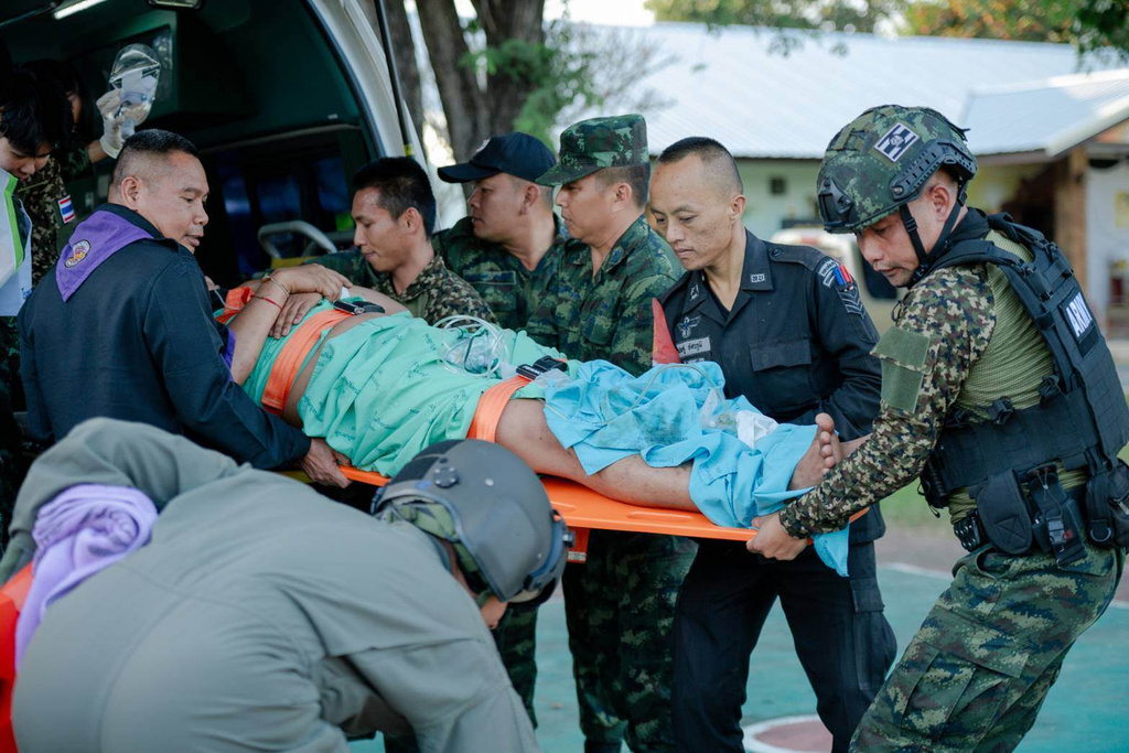 In this photo released by Royal Thai Army, a wounded Thai soldier is carried to be transferred to a hospital in Sisaket province, Thailand, Sunday, Dec. 7, 2025, after, according to a Thai army spokesperson, Cambodian troops fired into Thai territory. (Royal Thai Army via AP)