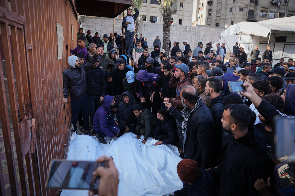 Palestinians mourn during the funeral of people who were killed in an Israeli military strike, at Nasser Hospital in Khan Younis, Gaza Strip, Thursday, Dec. 4, 2025. (AP Photo/Abdel Kareem Hana)