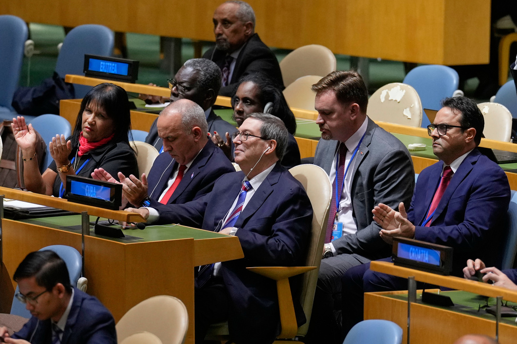 The Cuban delegation, including Cuban foreign minister Bruno Rodriguez Parrilla, center, reacts after a vote on ending the United States' blockade of Cuba at United Nations headquarters, Wednesday, Oct. 28, 2026. (AP Photo/Seth Wenig)