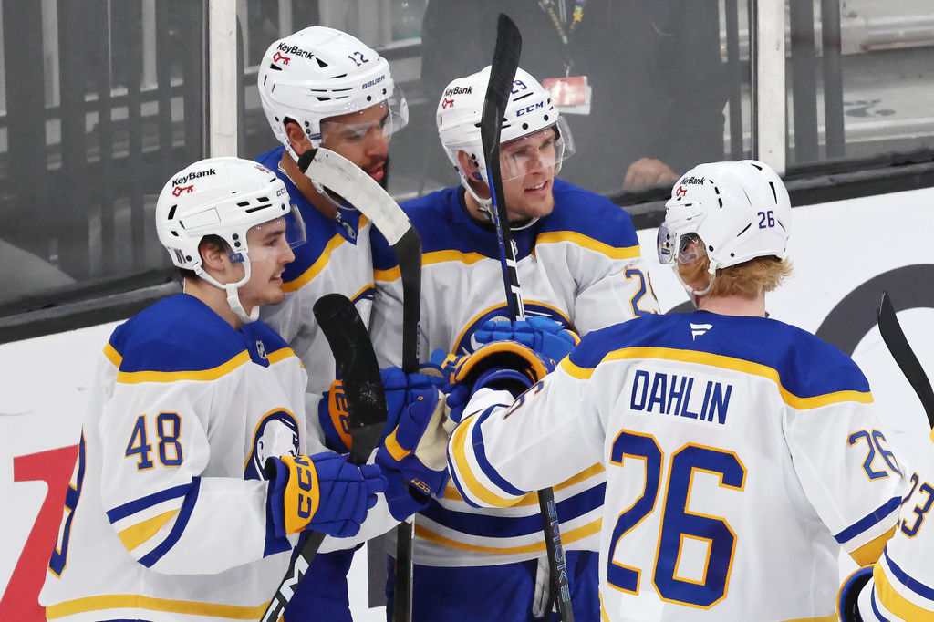 Buffalo Sabres' Beck Malenstyn (29) celebrates after his goal with teammates Tyson Kozak (48), Jordan Greenway (12) and Rasmus Dahlin (26) during the third period in Game 4 of a first-round NHL hockey Stanley Cup playoff series against the Boston Bruins, Sunday, April 26, 2026 against the Boston Bruins, in Boston. (AP Photo/Michael Dwyer)