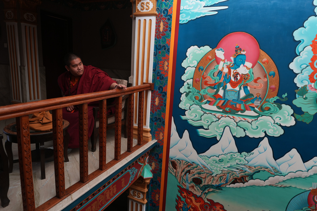 U.S.-born Buddhist lama Jalue Dorje pauses outside of his hotel room before he walks to nearby Shechen Monastery for a series of rituals and teachings in Kathmandu, Nepal, on Monday, April 6, 2026. (AP Photo/Luis Andres Henao)