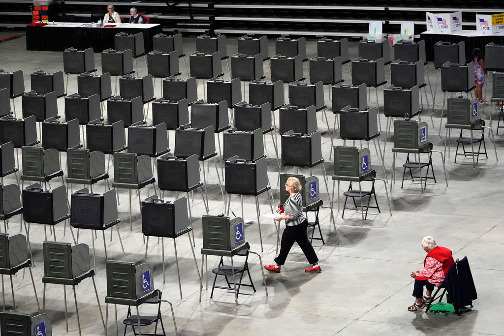 FILE - A voter has dozens of booths to choose from as she prepares to cast her ballot in Maine's primary election, June 11, 2024, in Bangor, Maine. (AP Photo/Robert F. Bukaty, File)