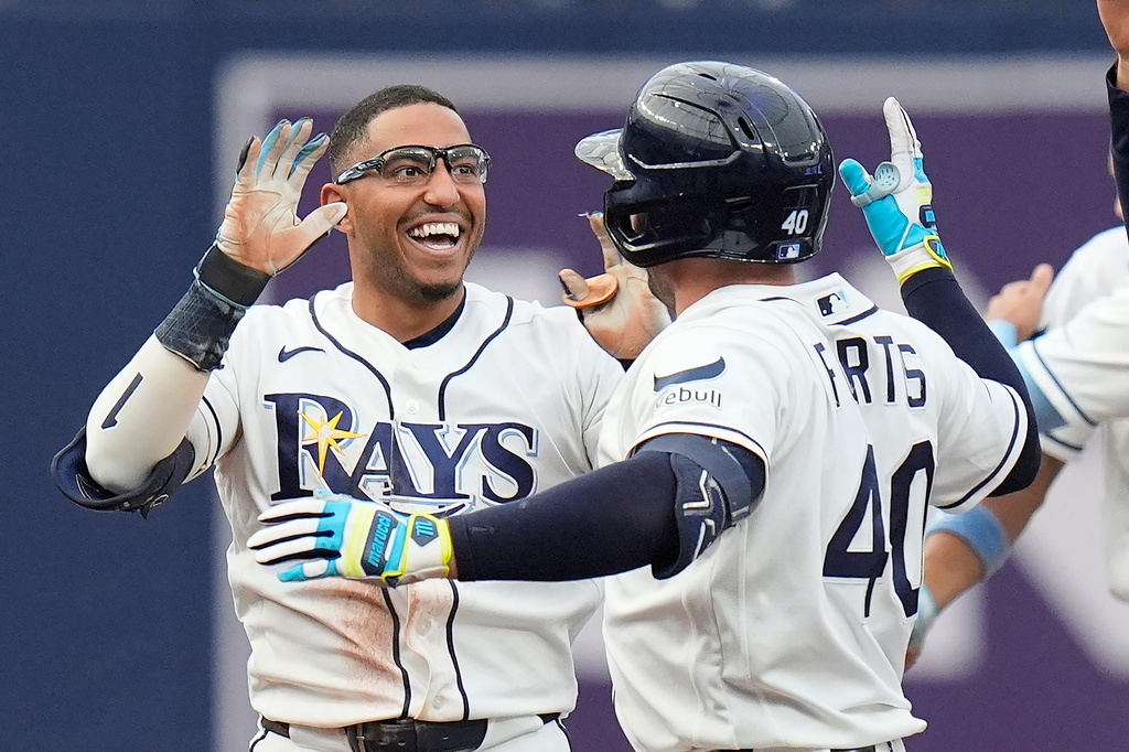 Tampa Bay Rays' Richie Palacios, left, celebrates his walkoff single off Boston Red Sox pitcher Garrett Whitlock with Nick Fortes during a baseball game Saturday, Sept. 19, 2026, in St. Petersburg, Fla. (AP Photo/Chris O'Meara)