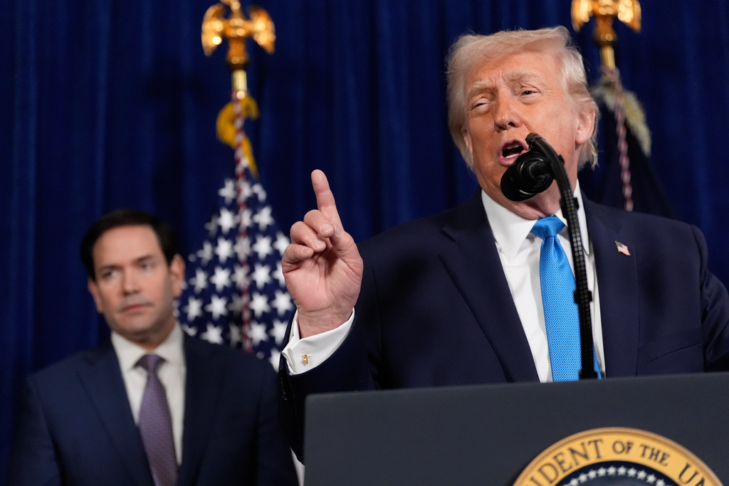 President Donald Trump speaks during a news conference at Mar-a-Lago, Saturday, Jan. 3, 2026, in Palm Beach, Fla., as Secretary of State Marco Rubio listens. (AP Photo/Alex Brandon)