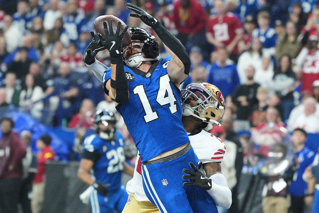 Indianapolis Colts wide receiver Alec Pierce (14) catches a touchdown pass against San Francisco 49ers cornerback Darrell Luter Jr. during the first half of an NFL football game, Monday, Dec. 22, 2025, in Indianapolis. (AP Photo/AJ Mast)