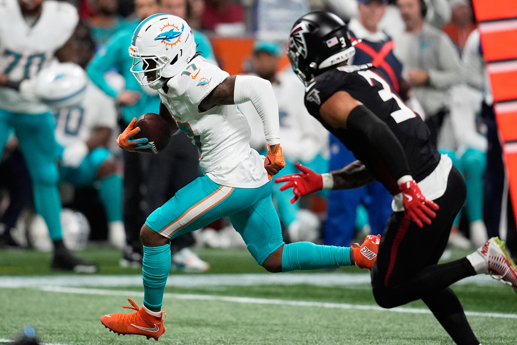 Miami Dolphins wide receiver Jaylen Waddle, left, runs past Atlanta Falcons safety Jessie Bates III (3) to score a touchdown during the second half of an NFL football game Sunday, Oct. 26, 2025, in Atlanta. (AP Photo/Mike Stewart)