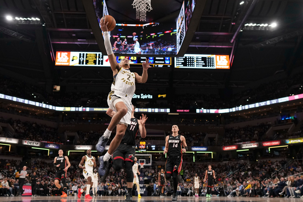Indiana Pacers guard Andrew Nembhard (2) shoots in front of Miami Heat forward Jaime Jaquez Jr. (11) during the first half of an NBA basketball game in Indianapolis, Saturday, Jan. 10, 2026. (AP Photo/AJ Mast)