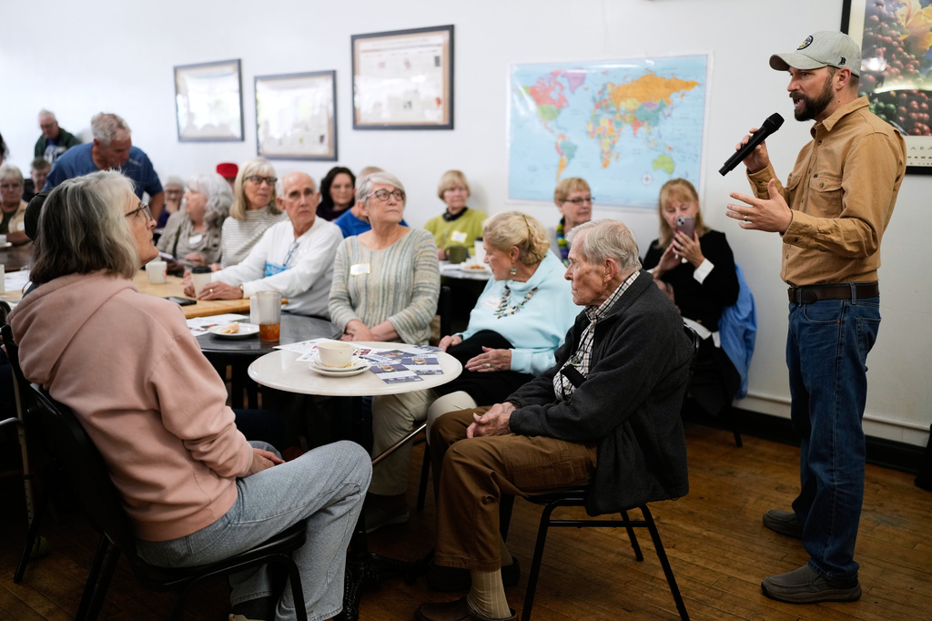 Democratic congressional candidate Mitchell Berman talks to supporters at Wilson's Coffee and Tea in Racine, Wis., Tuesday, Sept. 22, 2026. (AP Photo/Nam Y. Huh)