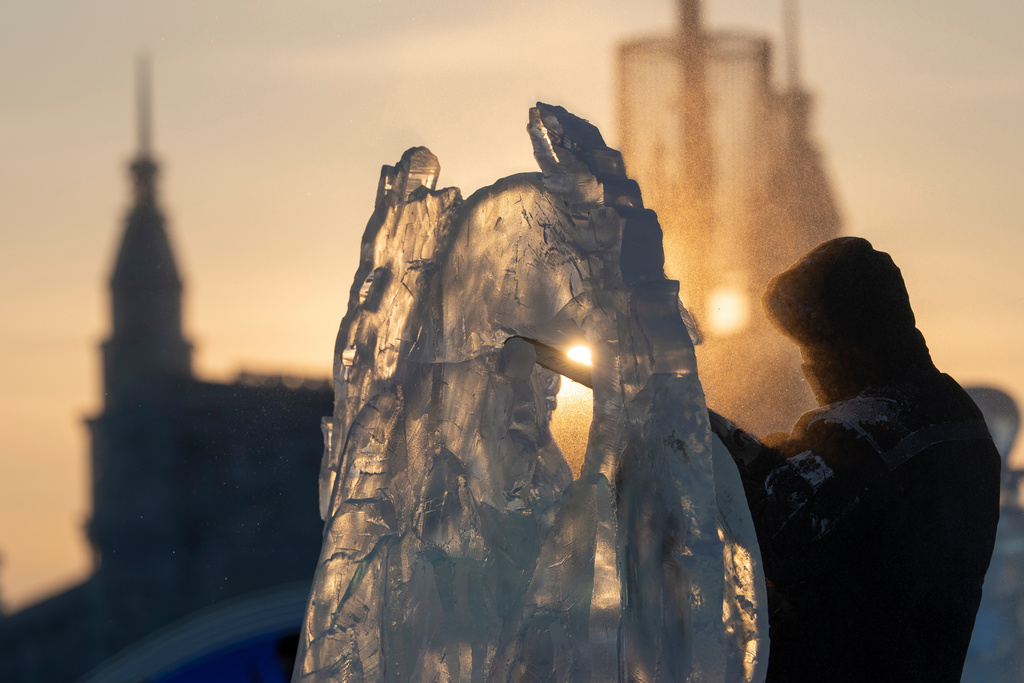An ice sculptor prepares his work for competition in the annual Ice and Snow Festival held in Harbin in China's Heilongjiang province on Saturday, Jan. 3, 2026. (AP Photo/Ng Han Guan)