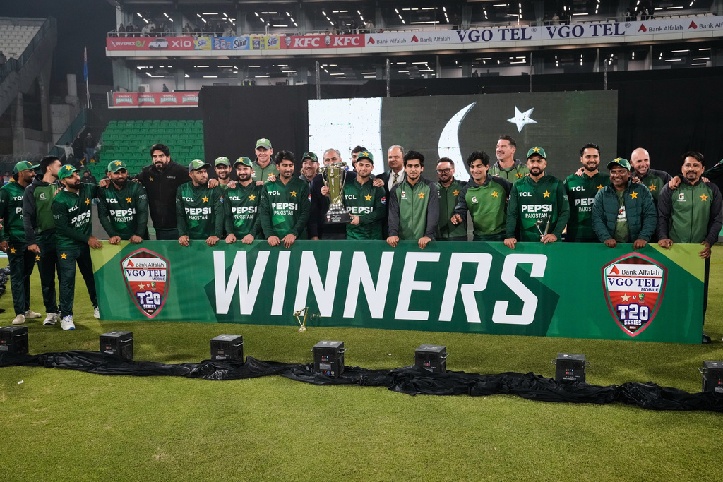 Pakistani players and official pose for photograph with the trophy after winning the T20 series against Australia on the end of the third T20 cricket match between Pakistan and Australia, in Lahore, Pakistan, Sunday, Feb. 1, 2026. (AP Photo/K.M. Chaudary)