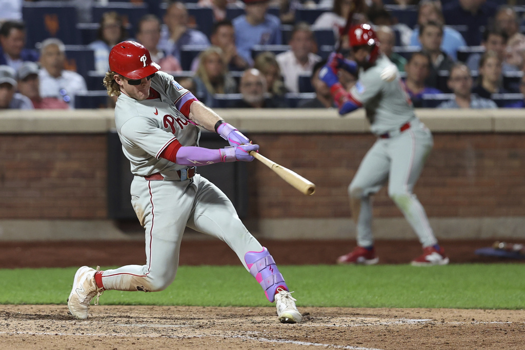 Philadelphia Phillies' Harrison Bader hits a two-run home run leading Nick Castellanos to score during the eighth inning of a baseball game against the New York Mets, Tuesday, Aug. 26, 2025, in New York. (AP Photo/Pamela Smith)