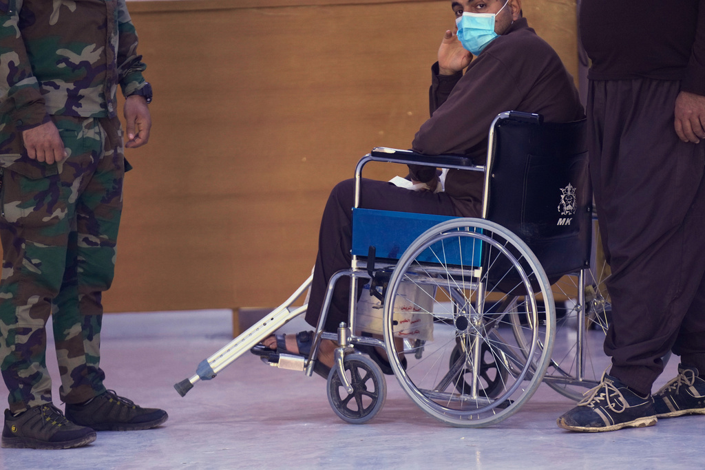 A suspected Islamic State militant who was transferred from Syria to Iraq, arrives for medical examination, in Al-Karkh Central Prison in Baghdad, Iraq, Thursday, Feb. 12, 2026. (AP Photo/Hadi Mizban)