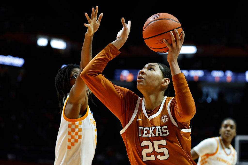 Texas forward Breya Cunningham (25) looks to shoot past Tennessee guard Jaida Civil, left, during the first half of an NCAA college basketball game in Knoxville, Tenn., Sunday, Feb. 15, 2026. (AP Photo/Wade Payne)