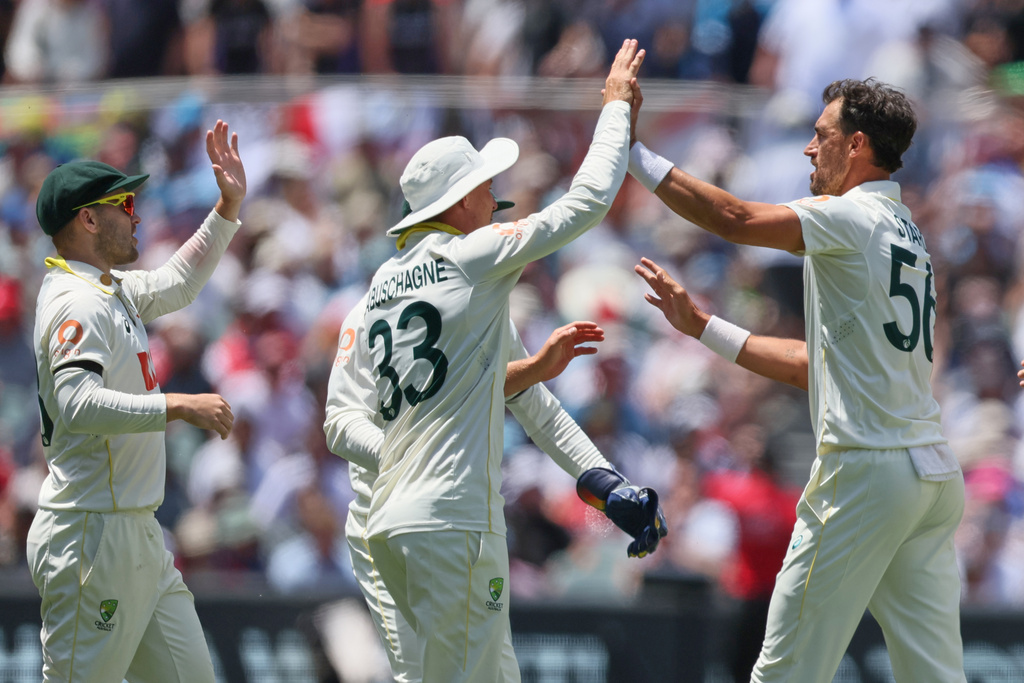 Australia's Mitchell Starc, right, celebrates the wicket of England's Jofra Archer with his teammates during play on the final day of the third Ashes cricket test between England and Australia in Adelaide, Australia, Sunday, Dec. 21, 2025. (AP Photo/James Elsby)