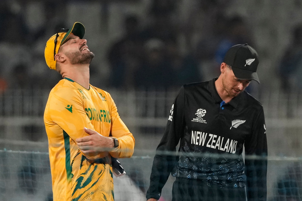 South Africa's captain Aiden Markram and New Zealand's captain Mitchel Santner talk during the toss at the start of the first T20 World Cup cricket semifinal match between them in Kolkata, India, Wednesday, March 4, 2026. (AP Photo/Anupam Nath)