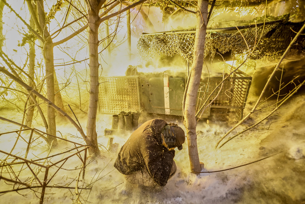 In this photo provided by Ukraine's 24th Mechanized Brigade press service, servicemen fire a 2S1 Gvozdika self propelled howitzer towards Russian positions near Chasiv Yar town, Donetsk region, Ukraine, Sunday, Jan. 18, 2026. (Oleg Petrasiuk/Ukraine's 24th Mechanized Brigade via AP)