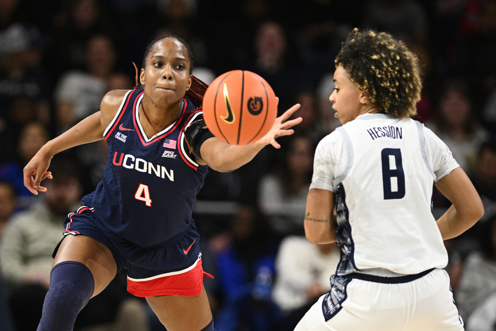 UConn guard Blanca Quinonez (4) raps the ball against Georgetown guard Khadee Hession (8) during the first half of an NCAA college basketball game, Thursday, Jan. 22, 2026, in Washington. (AP Photo/Nick Wass)