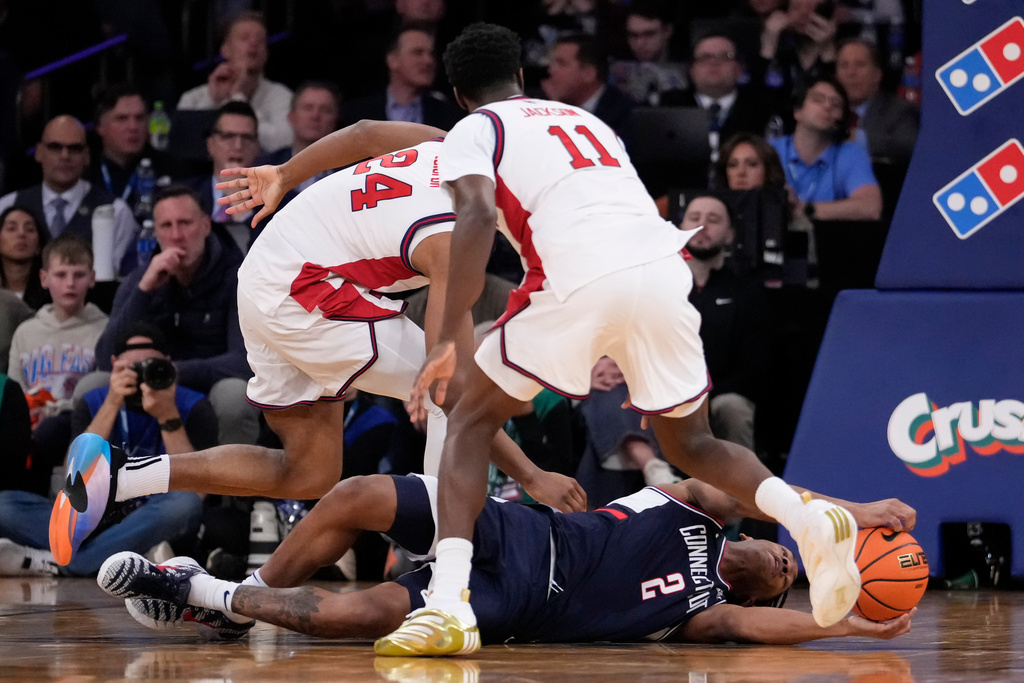 UConn guard Silas Demary Jr. (2) jumps for the ball during the first half of an NCAA college basketball game against St. John's in the championship of the Big East tournament, Saturday, March 14, 2026, in New York. (AP Photo/Yuki Iwamura)